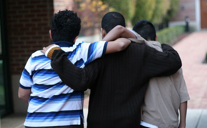 Three Kids With Arms Across Shoulders