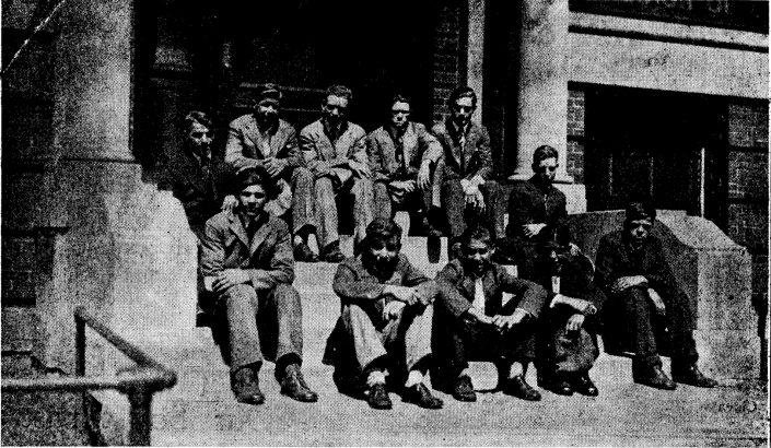 Young men sit on the front steps of Mercy Home.