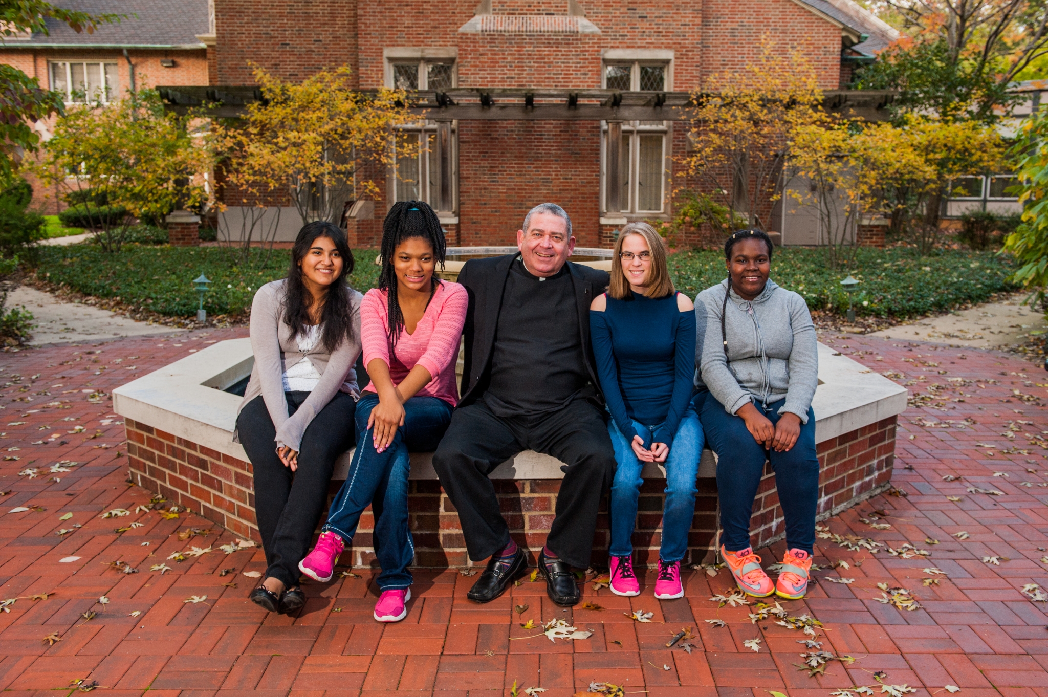 Fr. Scott visits with girls at our Walsh Campus