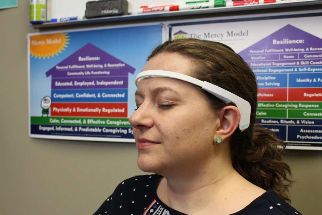 Emily Neal with neurofeedback equipment