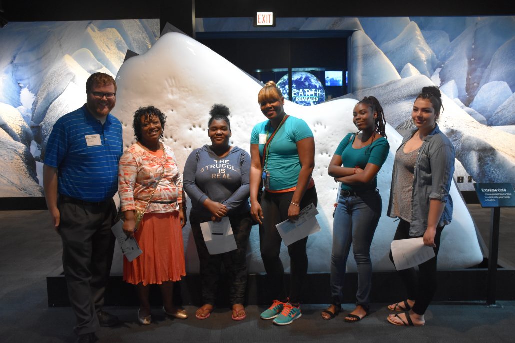 Students posing in front of backdrop