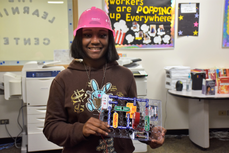 Young woman showing off project