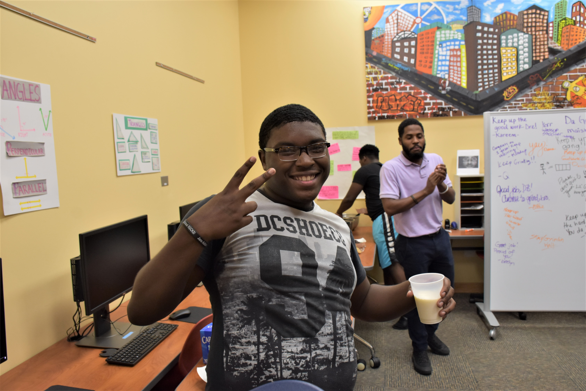 Mercy Home youth smiling in computer lab