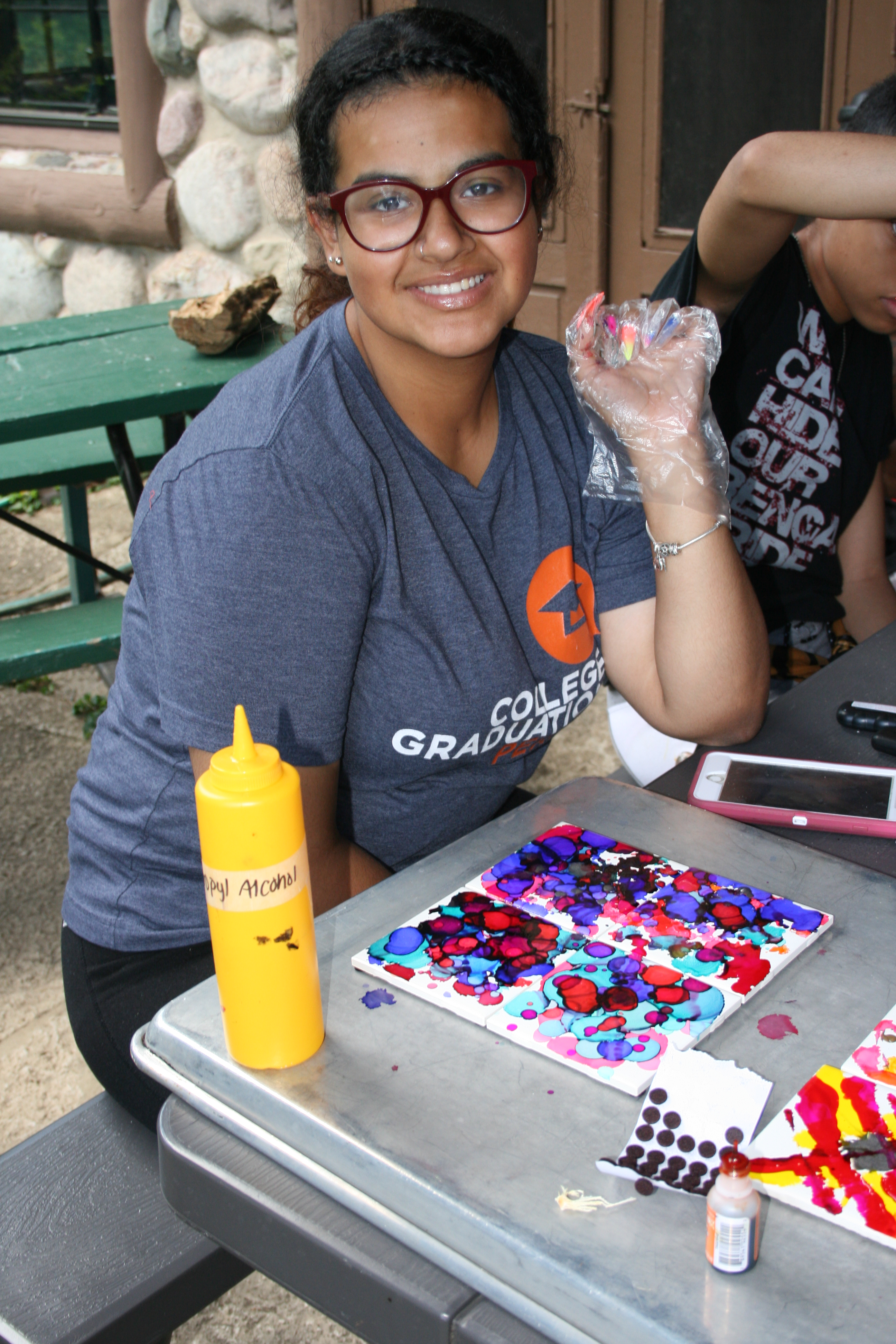 Girl working on watercolor painting at the AfterCare Scholar Retreat