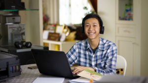 Young man works on his laptop