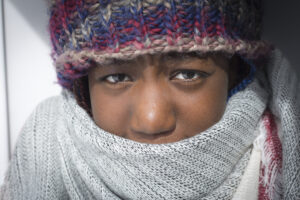 Aisha outside in winter hat and scarf