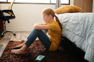 Teen girl sitting on the floor