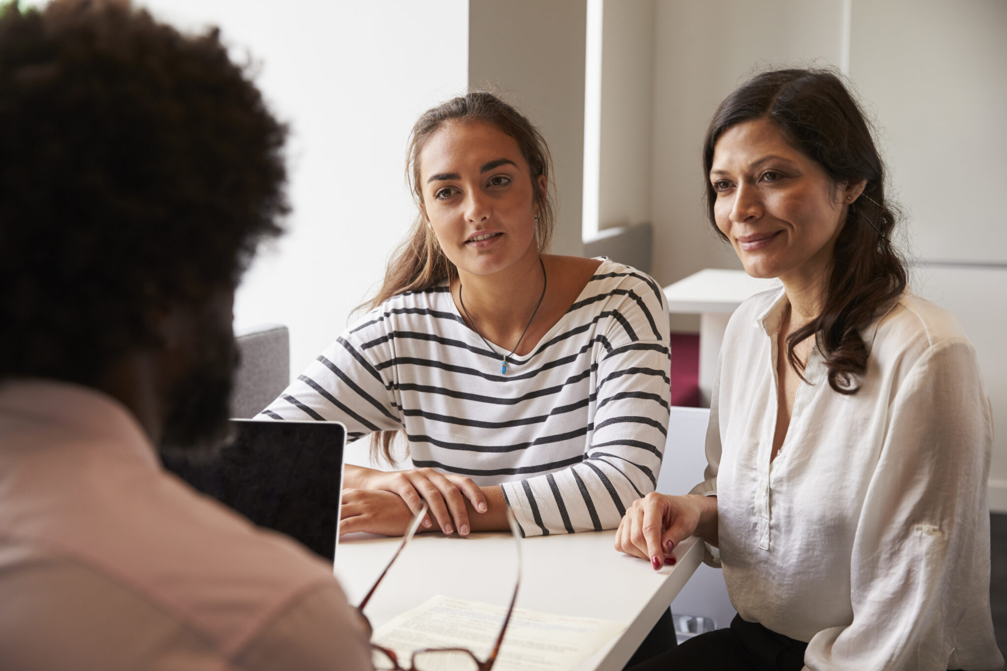 Mother and daughter meet with teacher