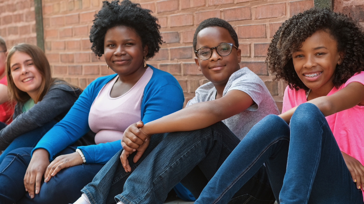 kids sit outside of Mercy Home