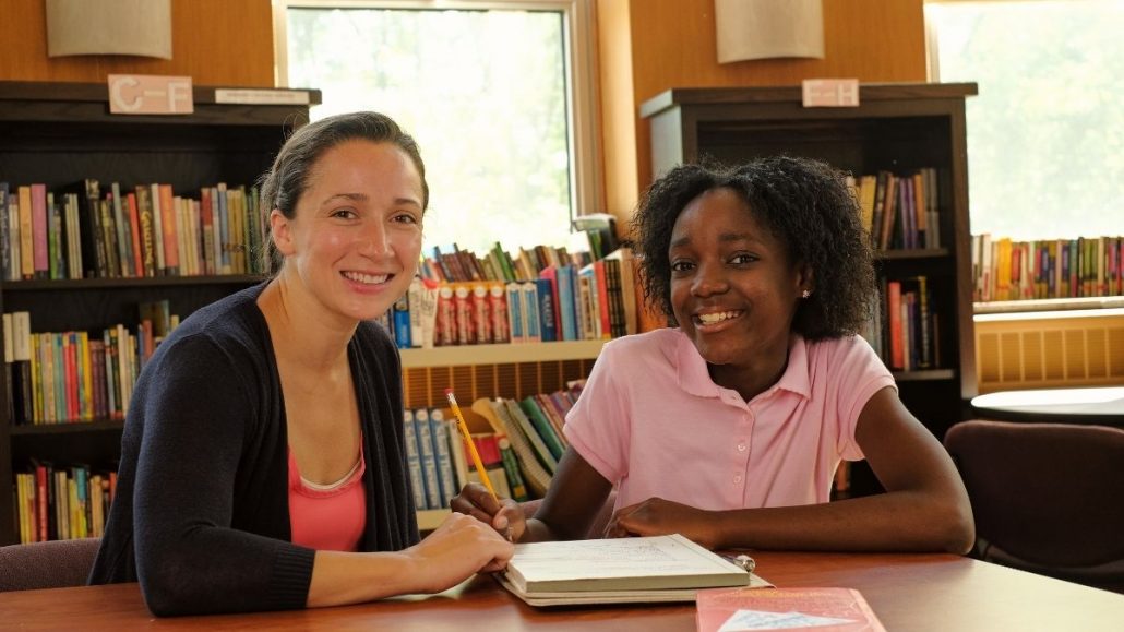 Young girl being tutored by lady
