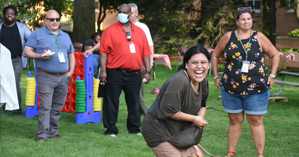 At the Mercy Home annual Field Day, a woman crouches in anticipation of an incoming water balloon