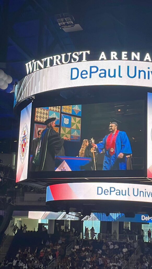 Clemente walks across the stage at his DePaul graduation