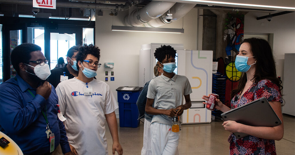 Maura Carr pauses her tour of Google's West Loop campus to share a story with Mercy Home kids about her experience in her field and life as a Google employee.