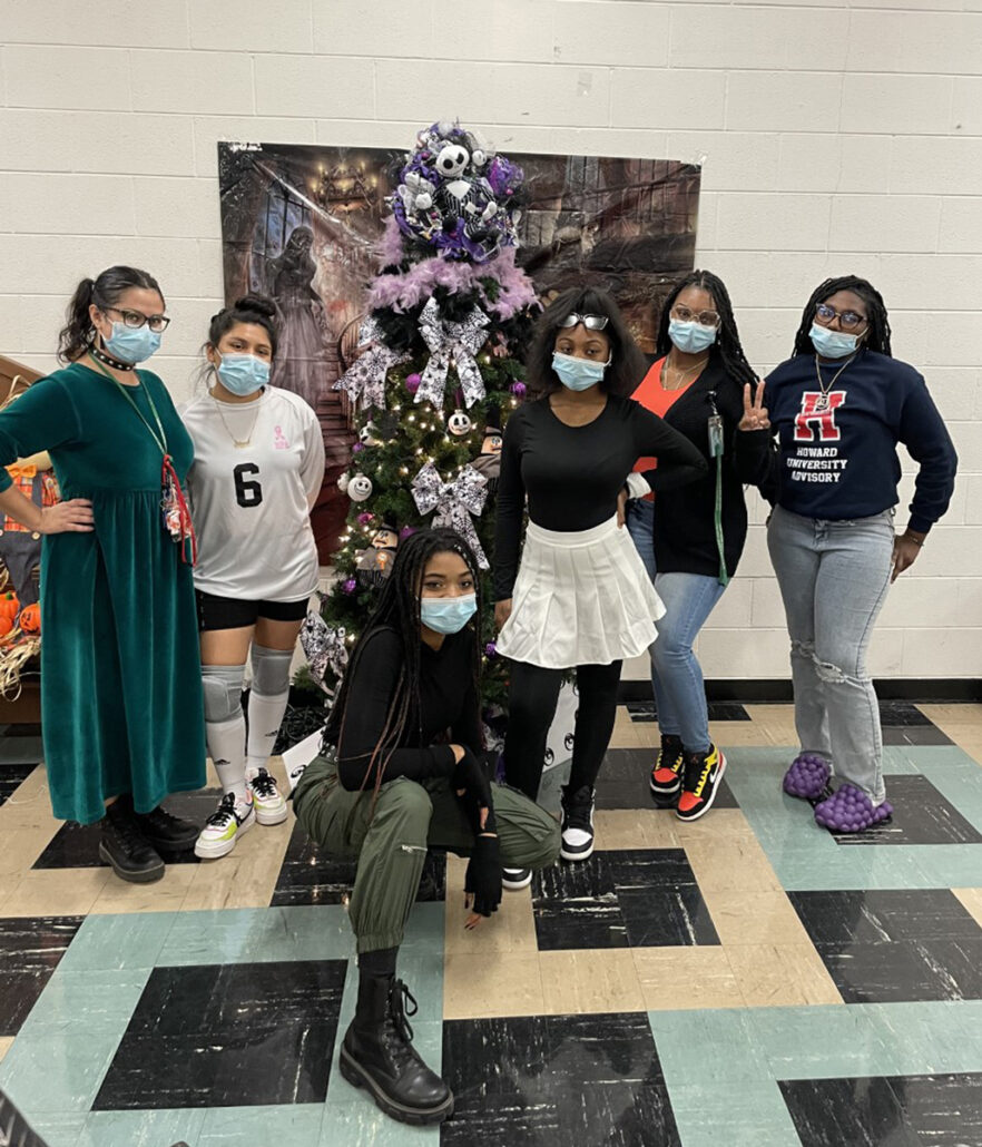 Our girls got together for a group photo. They stand in front of a Halloween-decorated tree, like a Christmas tree.