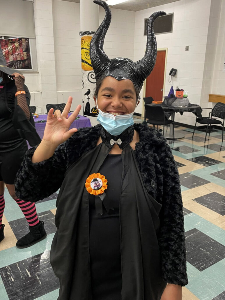 Alexa won best-costume as Maleficent! In addition to her large black horns and cape, she bears an orange ribbon for her stellar creativity.