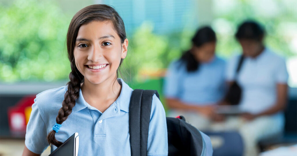 While carrying her backpack and notebook, Annaliese stops for a quick photo before doing some studying. 