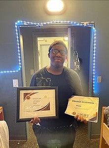 Tyler holds his awards