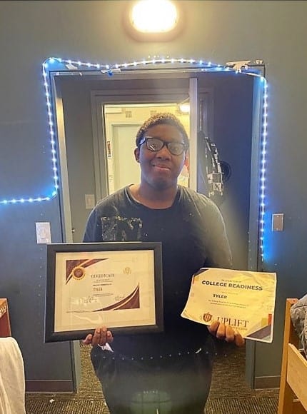 Tyler holds his awards