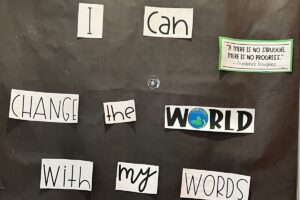 A door is decorated with the empowering sentence " I can change the world with my words" as part of the kids' celebration of Black History Month.