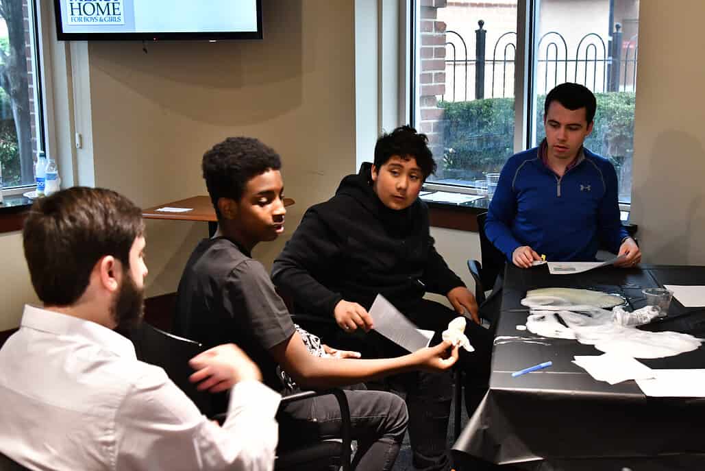 young boys sitting around a table