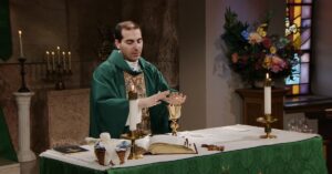 Fr. James Wallace raises his hands to bless this week's communion as he leads the Sunday Mass community at Mercy Home in celebration of the Twenty-Second Sunday in Ordinary Time.