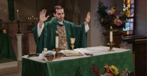 Fr. James Wallace raises his hands to bless this week's communion as he leads the Sunday Mass community at Mercy Home in celebration of the Twenty-Fourth Sunday in Ordinary Time.