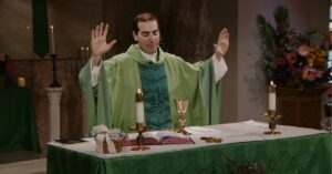 Fr. James Wallace raises his hands to bless this week's communion as he leads the Sunday Mass community at Mercy Home in celebration of the Twenty-Fifth Sunday in Ordinary Time.