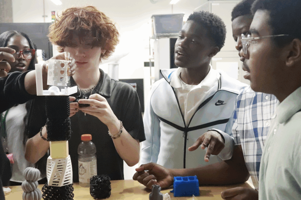 A group of youth conduct a science experiment together.