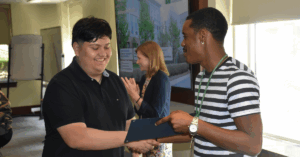 A Mercy Home youth receives an award for his hard work.